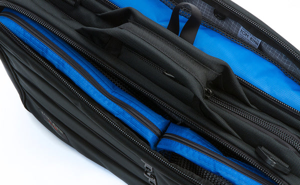 A close shot of Black Tri-Star filled with one each of a Small, Medium, and Large Tri-Star Packing Cube.